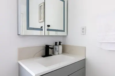 a white bathroom with a sink and a mirror at Walking distance to Caltech convention Center Pasadena Landmark room in Pasadena