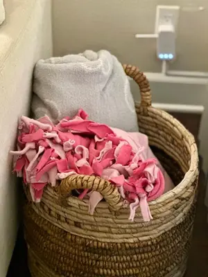 a basket filled with towels and pink clothes at Cozy Gem Near Old Town Pasadena in Pasadena