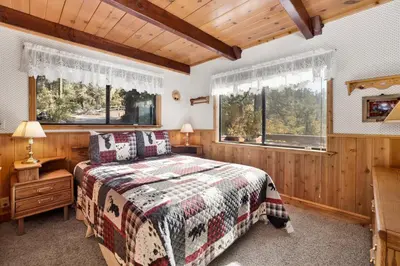a bedroom with a bed and two windows at Mountain Hideaway on Maryland #2494 in Big Bear Lake