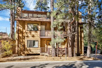 a house with a balcony and trees in front at Buttercup #2508 in Big Bear Lake