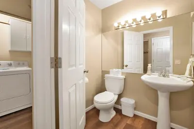 a white bathroom with a toilet and a sink at Castle Glen Gem #2220 in Big Bear Lake