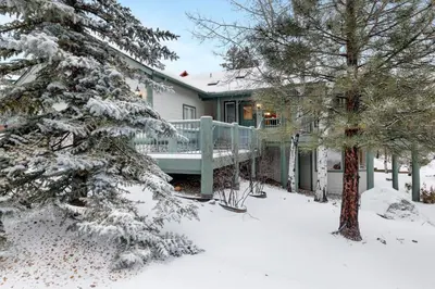 a house with a deck in the snow at Castle Glen Gem #2220 in Big Bear Lake