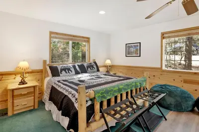 a bedroom with a bed and two windows at Lookout Lodge #2128 in Big Bear City
