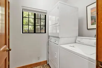 a kitchen with white appliances and a window at Serenity Cove Lake House #2472 by Big Bear Vacations in Big Bear Lake