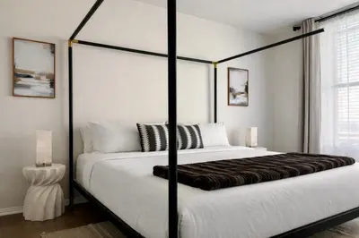 a bedroom with a large bed with a black frame at Beautiful Getaway Near Venice in Los Angeles