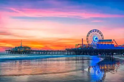 a pier with a ferris wheel on the beach at sunset at Beautiful Getaway Near Venice in Los Angeles