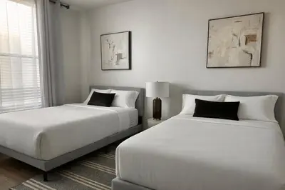 two white beds in a room with a window at Beautiful Getaway Near Venice in Los Angeles