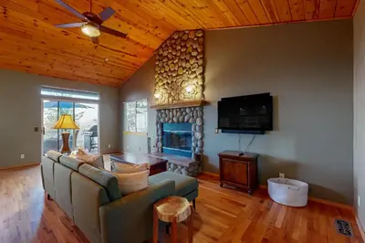 a living room with a couch and a fireplace at Cloud Nine in Lake Arrowhead