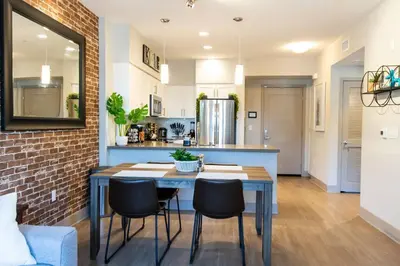 a kitchen and dining room with a blue table and chairs at 3 Miles to Disney Heated Pool CnvntnCtr Jacuzzi in Fullerton