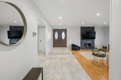 a living room with a door and a mirror at Spacious House, Central, All Amenities in Harbor City