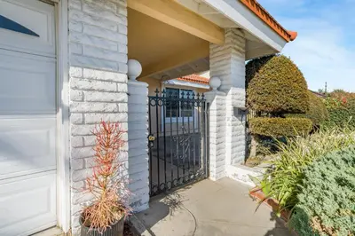 a driveway with a black gate in a house at Spacious House, Central, All Amenities in Harbor City