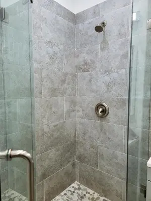 a shower stall with a glass door with a shower at Modern Studio apartment right next to MrC hotel 5 minutes to Rodeo Drive in Los Angeles