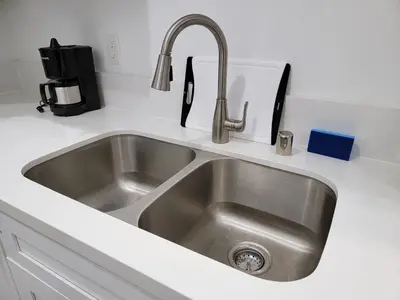 a stainless steel sink in a kitchen at Modern Studio apartment right next to MrC hotel 5 minutes to Rodeo Drive in Los Angeles