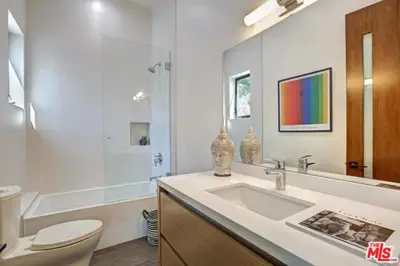 a bathroom with a sink and a toilet and a tub at Sycamore Ave in Los Angeles