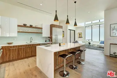 a large kitchen with a large island with bar stools at Sycamore Ave in Los Angeles