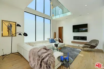 a living room with a white couch and a table at Sycamore Ave in Los Angeles