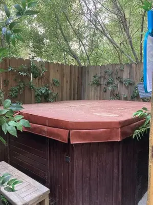 a wooden fence with a red table on it at Beautiful A-Frame Mountain Cabin with Hot Tub! in Running Springs