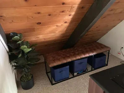 a bench sitting in the corner of a room at Beautiful A-Frame Mountain Cabin with Hot Tub! in Running Springs