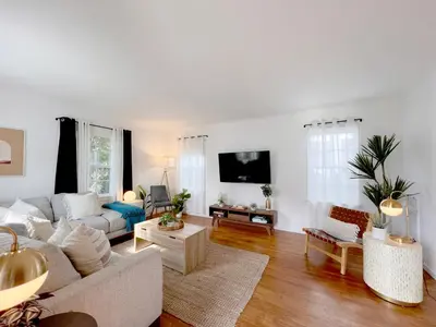 a living room with a couch and a tv at The Culver Retreat Family Oasis w Office Backyard in Los Angeles
