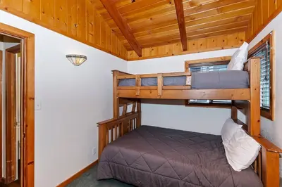 a bedroom with two bunk beds in a cabin at Village Hideaway walking to the village in Big Bear Lake
