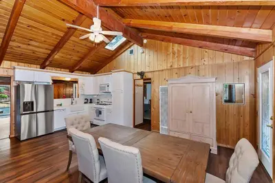 a kitchen and dining room with a wooden table and chairs at Village Hideaway walking to the village in Big Bear Lake
