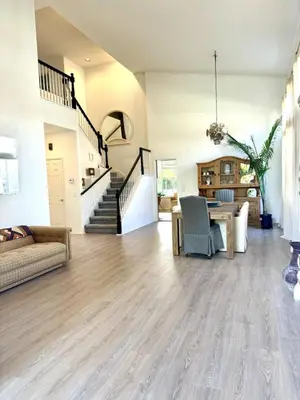 a large living room with a table and a staircase at Entire Fully Furnished Home in Camarillo California. 10 Mins from the beach in Camarillo
