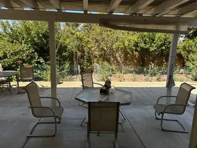 a patio with chairs and a table and a table and chairs at Entire Fully Furnished Home in Camarillo California. 10 Mins from the beach in Camarillo