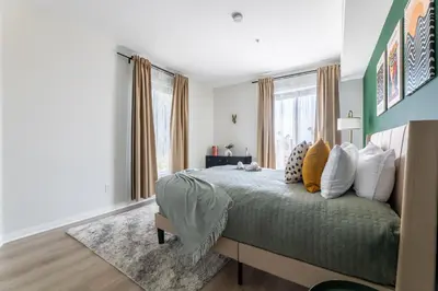 a bedroom with a bed with a green comforter at Cozy 2BD Retreat in MarinaDelRey!Free Parking&Pool in Los Angeles