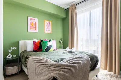 a green bedroom with a bed and a window at Cozy 2BD Retreat in MarinaDelRey!Free Parking&Pool in Los Angeles