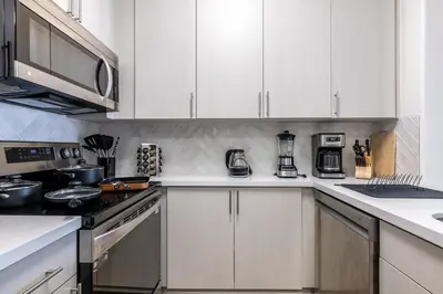 a kitchen with white cabinets and a stove top oven at Cozy 2BD Retreat in MarinaDelRey!Free Parking&Pool in Los Angeles