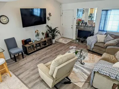 a living room with a couch and a tv at 5 Minutes to South Bay Beaches! Private 2 bedroom 2 bath 2 level home with patio Excellent value! in Torrance