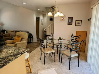 a dining room with a glass table and chairs at 5 Minutes to South Bay Beaches! Private 2 bedroom 2 bath 2 level home with patio Excellent value! in Torrance