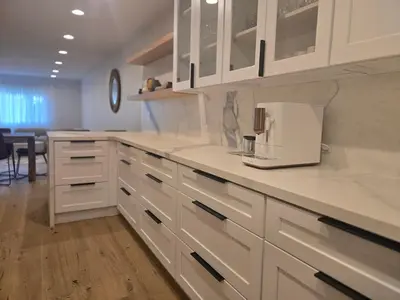a kitchen with white cabinets and a coffee maker on the counter at NEW 2BD Majestic Gateway in Glendale in Glendale