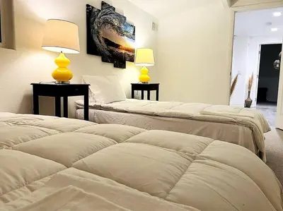 two beds in a room with two lamps on tables at Mediterranean Villa-Pool Jacuzzi BBQ-Malibu Bliss in Los Angeles