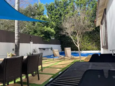 a patio with chairs and a table and a pool at Mediterranean Villa-Pool Jacuzzi BBQ-Malibu Bliss in Los Angeles