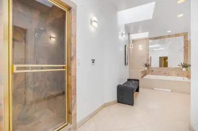 a large bathroom with a shower and a tub at Franklin Mediterranean Villa in Los Angeles