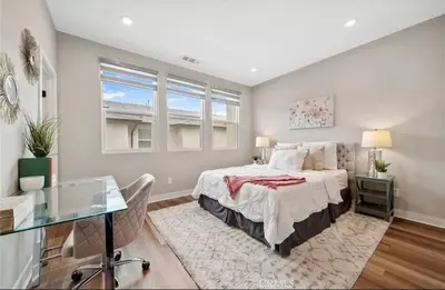 a bedroom with a large bed and a desk at 1311WCara in Anaheim