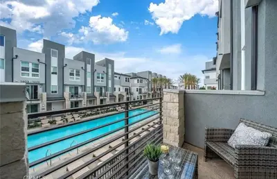 a balcony with a view of a swimming pool at 1311WCara in Anaheim