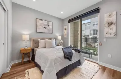 a bedroom with a bed and a large window at 1311WCara in Anaheim
