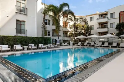 a swimming pool in front of a building at Cozy Large 1 Bedroom Condo by UCLA in Los Angeles