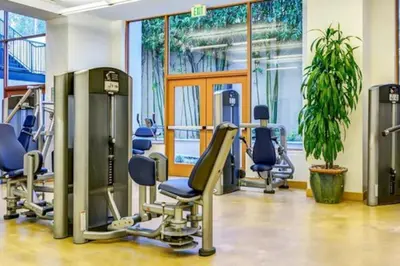 a gym with treadmills and chairs in a room at Cozy Large 1 Bedroom Condo by UCLA in Los Angeles
