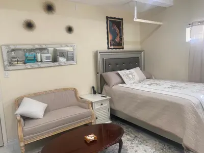 a bedroom with a bed and a chair and a table at Hidden Gem in Stevenson Ranch