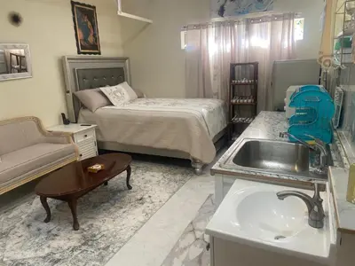 a bathroom with a sink and a bedroom with a bed at Hidden Gem in Stevenson Ranch