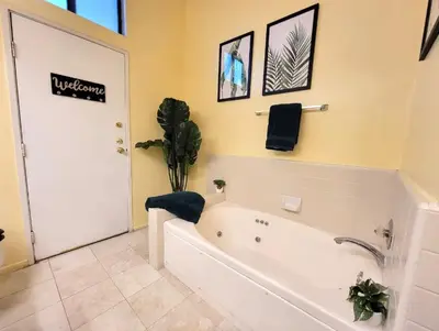 a bathroom with a bath tub with a plant in it at Spacious studio with two queen beds near Beverlywood 5 minutes to Rodeo Drive in Los Angeles
