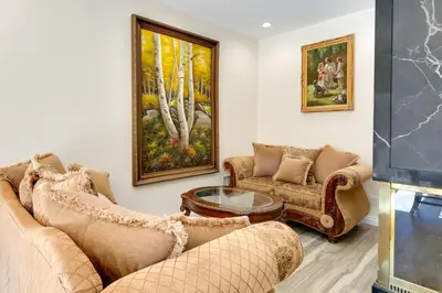 a living room with two couches and a table at Game Room and Deck Modern Frazier Park Home! in Pine Mountain Club