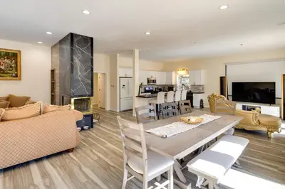 a dining room and living room with a table and chairs at Game Room and Deck Modern Frazier Park Home! in Pine Mountain Club