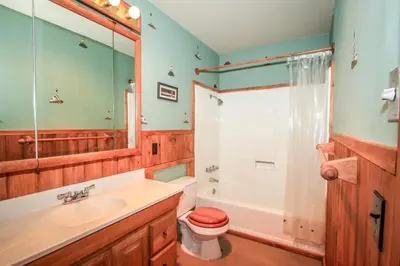 a bathroom with a sink and a toilet and a shower at A Big Olympic Getaway in Big Bear Lake