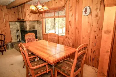a dining room with a wooden table and chairs at A Big Olympic Getaway in Big Bear Lake