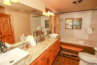 a bathroom with a sink and a toilet and a tub at Summit Lodge 1 in Big Bear Lake
