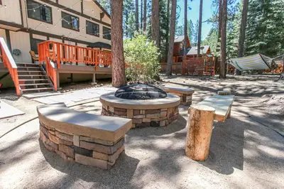 a patio with a fire pit and benches and a building at Summit Lodge 1 in Big Bear Lake